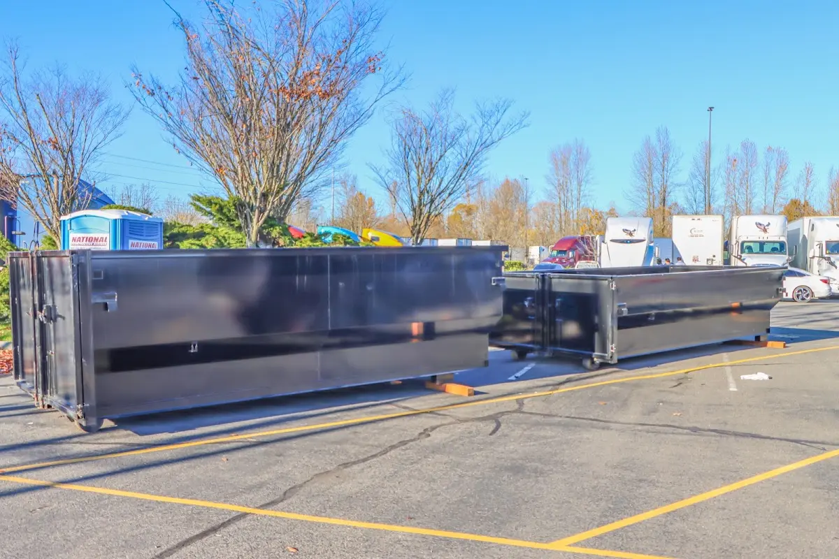 Professional dumpster rental service with roll-off container on residential driveway in Cabot